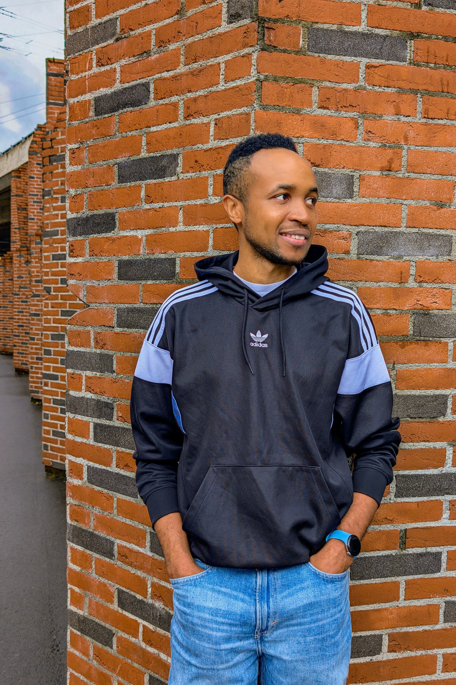 Adidas hoodie street portrait against brick